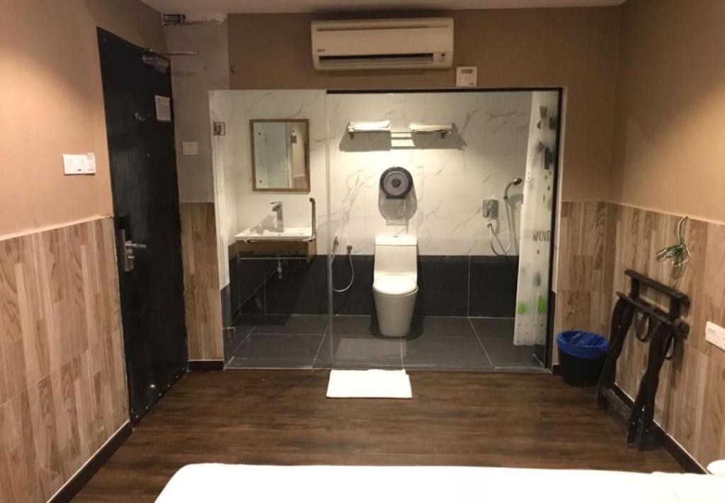 a bathroom with a toilet and a sink at Time Hotel in Seremban