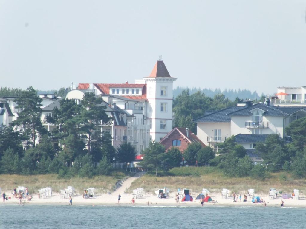 a group of people on a beach near the water at Pension Haus Edelweiß in Binz