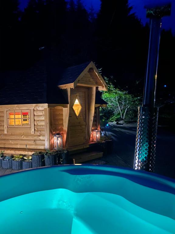 a log cabin at night with a swimming pool at Irena in Korbielów
