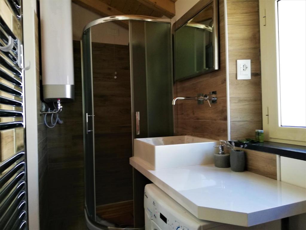 a bathroom with a sink and a shower at Casa Vacanza L'Ulivo in Albenga