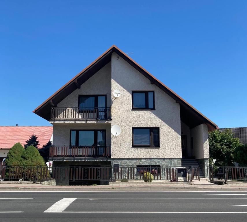 a building with a gambrel roof on the side of a street at Pension Barborka in Jičín