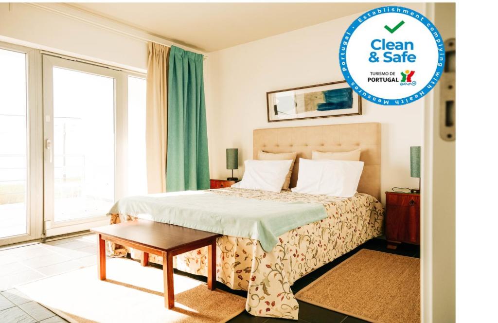 a hotel room with a bed and a window at Casa das Barcas in Lourinhã