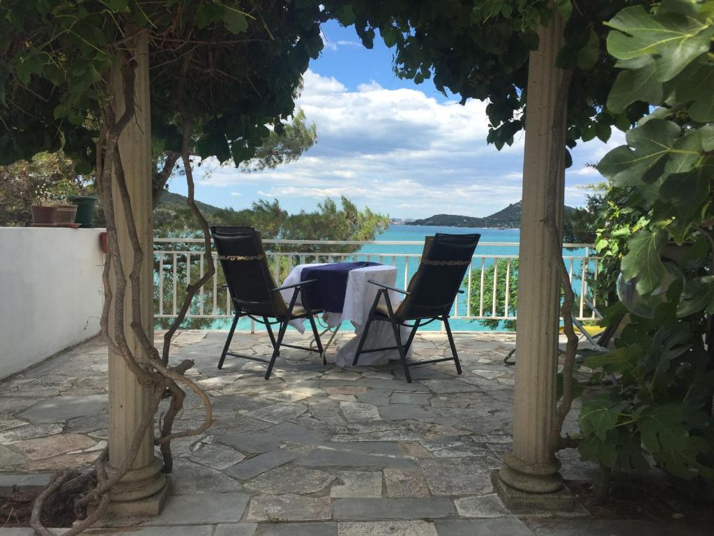 a table and chairs on a patio with a view of the ocean at Tisno Sea View apartment in Tisno