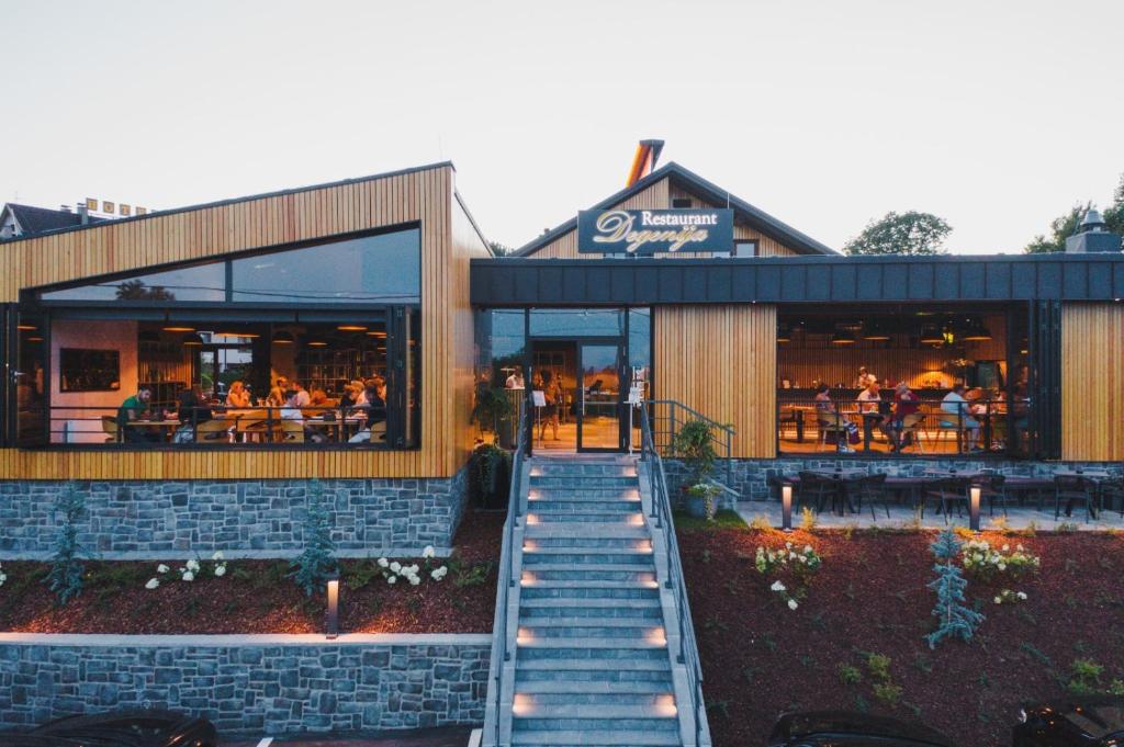 a restaurant with people sitting inside of it at Hotel Degenija in Seliste Dreznicko