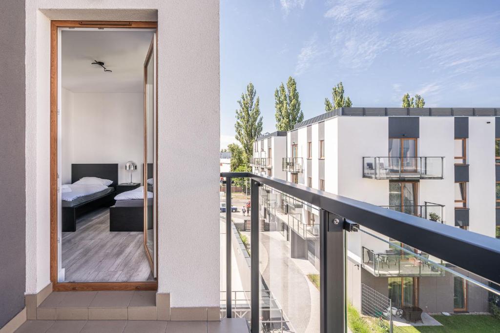 an apartment balcony with a view of a bedroom at RentPlanet - Apartamenty Na Grobli in Wrocław