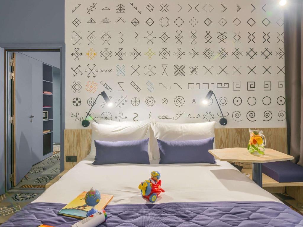 Un pat sau paturi într-o cameră la ibis Styles Bucharest City Center