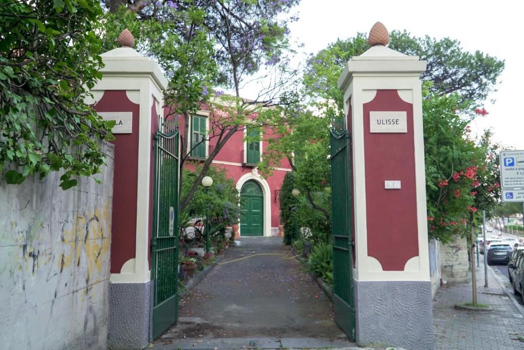 una puerta a una casa roja con una calle en Villa Ulisse, en Ercolano