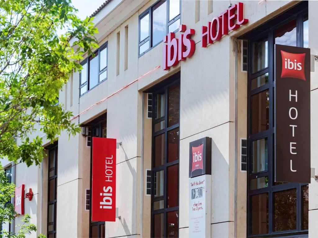 a building with signs on the side of it at ibis Avignon Centre Pont De L'Europe in Avignon