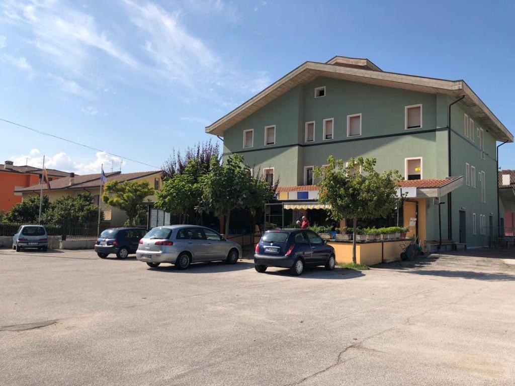a parking lot with cars parked in front of a building at Il Portichetto in LʼAquila