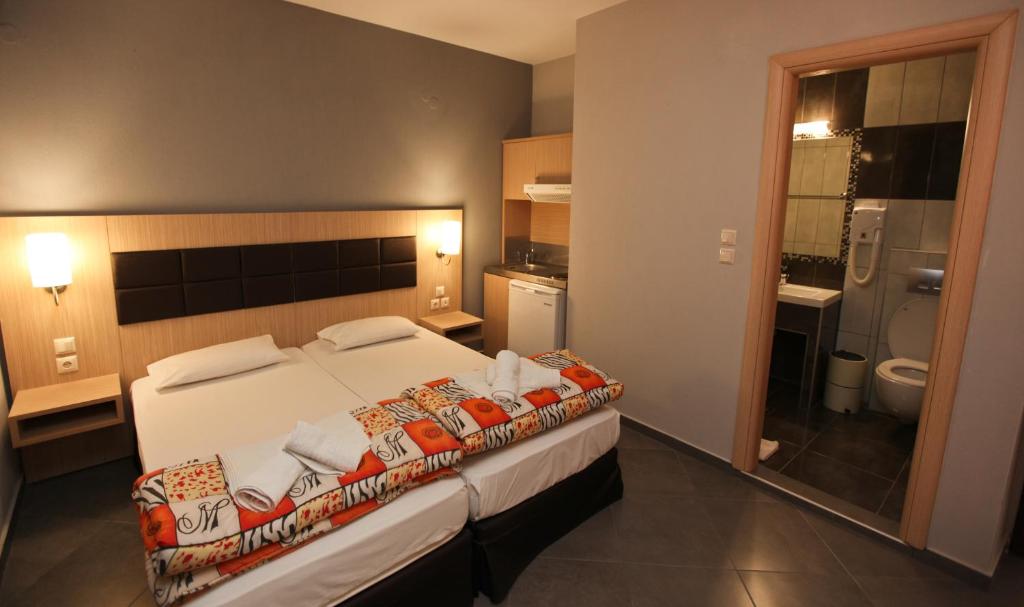 a hotel room with a bed and a bathroom at Mironi & Victoria Hotel in Limenas