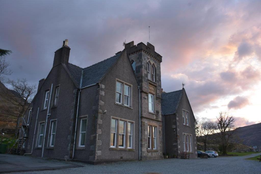 an old building with a clock tower on top of it at Sconser Lodge Hotel in Sconser