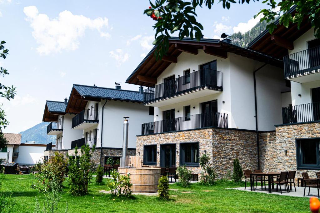 an exterior view of a building with a yard at Alpenchalet Montafon in Gaschurn