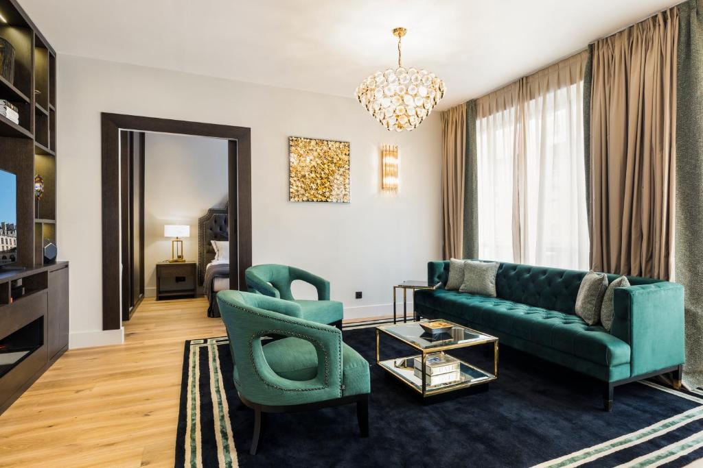 Luxury Apartment Paris Louvre II في باريس: غرفة معيشة مع أريكة وكرسيين