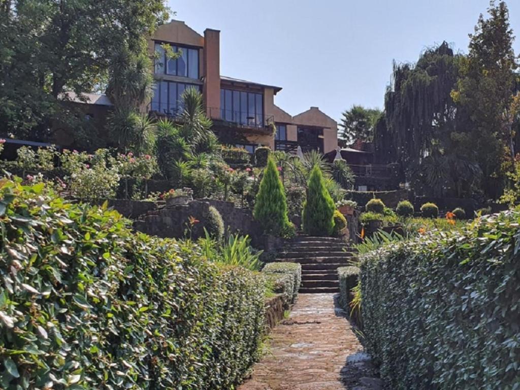 a house with stairs leading to a garden at Black Horse Estate in Magaliesburg