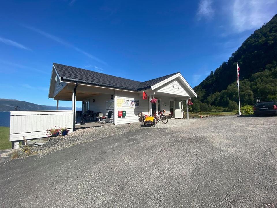 a building with a car parked in front of it at Botnen Camping in Botnen