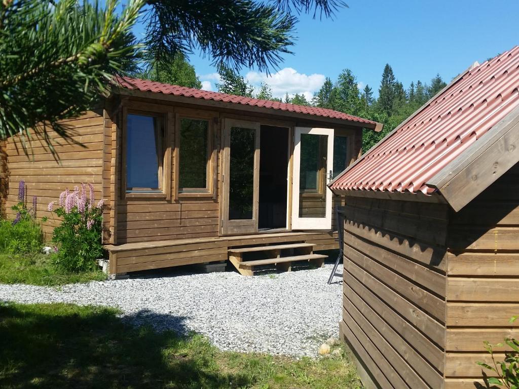 una piccola cabina con portico accanto di Cozy Lodge and tiny lodge 5 pers. a Filipstad