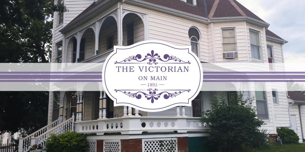 a sign for the victorian on main in front of a house at The Victorian on Main in Fairfield