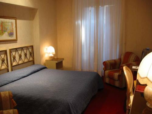 Postel nebo postele na pokoji v ubytování Hotel Eliseo