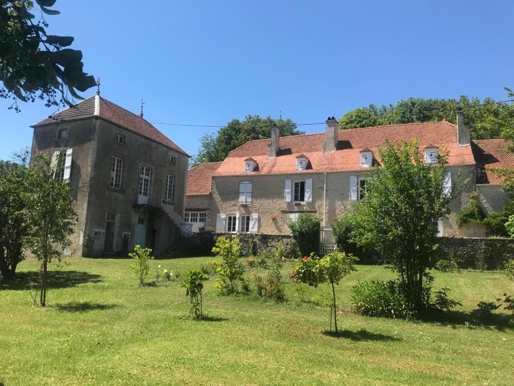 an old house with a garden in front of it at Chez Zoiseau et Zoiseautte in Chassigny