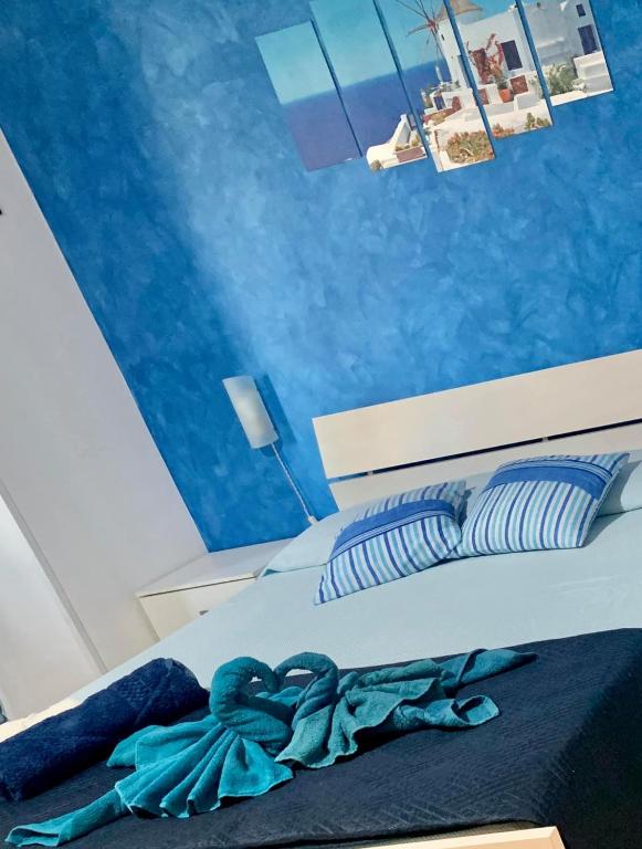 sypialnia z łóżkiem z niebieskimi ścianami w obiekcie B&b Cefalù w Cefalù