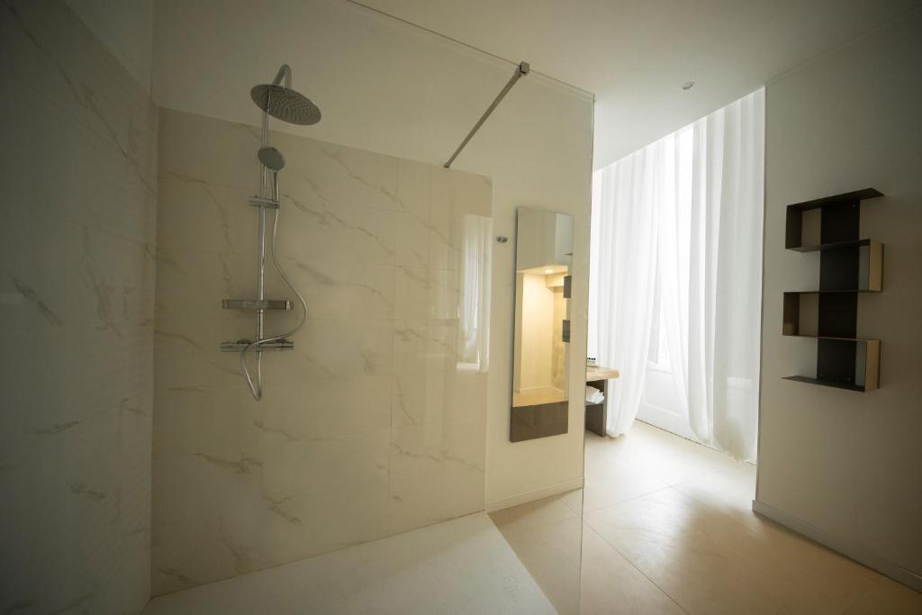 a bathroom with a shower with a glass wall at BARI 102 in Bari