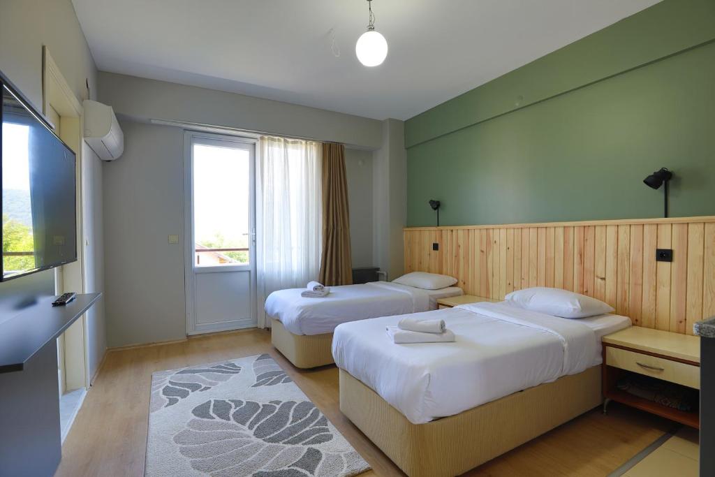 Postel nebo postele na pokoji v ubytování Kayi Apart Hotel