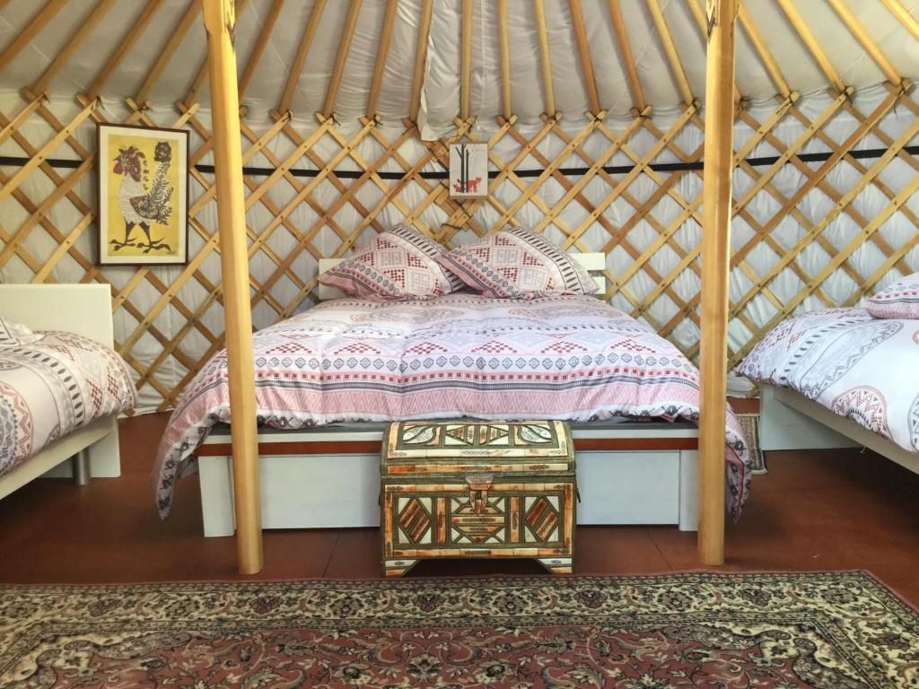 a bedroom with a bed in a yurt at Yourtes Lacroutz in Nassiet
