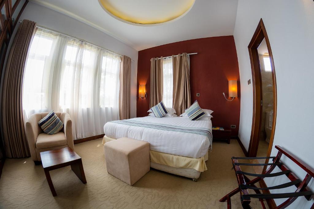 Imperial Heights Hotel, Entebbe tesisinde bir odada yatak veya yataklar