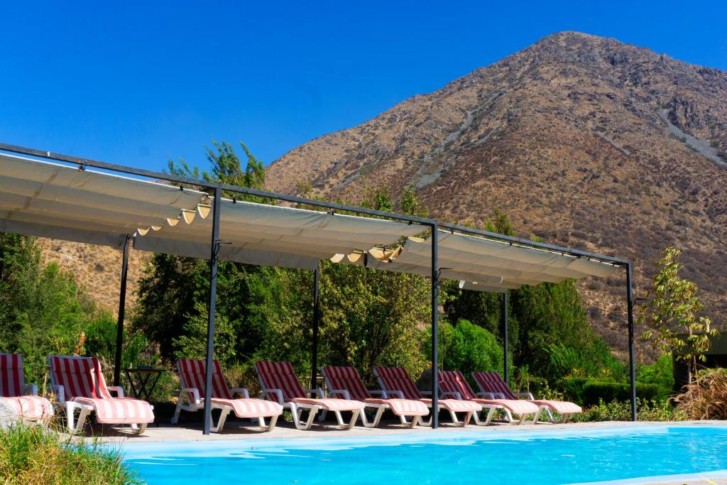 a large pool of water surrounded by trees at Lodge del Maipo in San José de Maipo