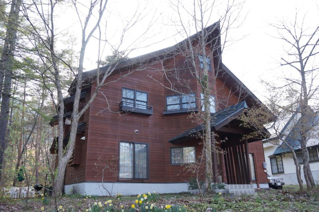 a large red brick house with a gambrel at Creek House Hakuba - Vacation STAY 87290 in Hakuba