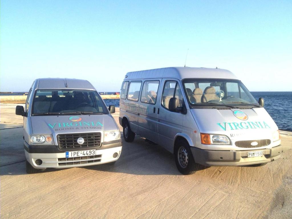 two vans parked next to each other on the beach at Virginia Hotel in Tinos Town