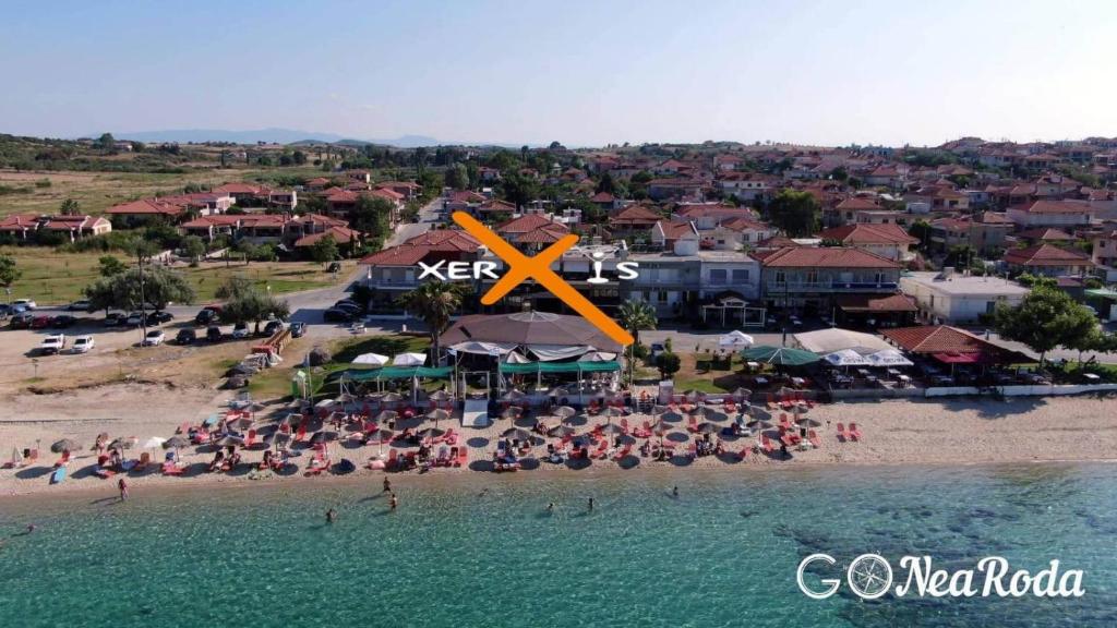 an aerial view of a beach with people on the sand at Xerxis Studios in Nea Roda