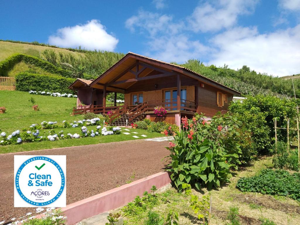 a house with a sign in front of it at Quinta da Pavoa - Cottage House in Vila Franca do Campo