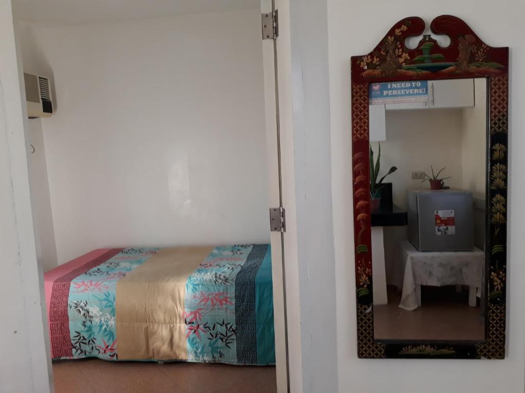 a bedroom with a bed and a mirror at Rent! Monthly or More in San Juan