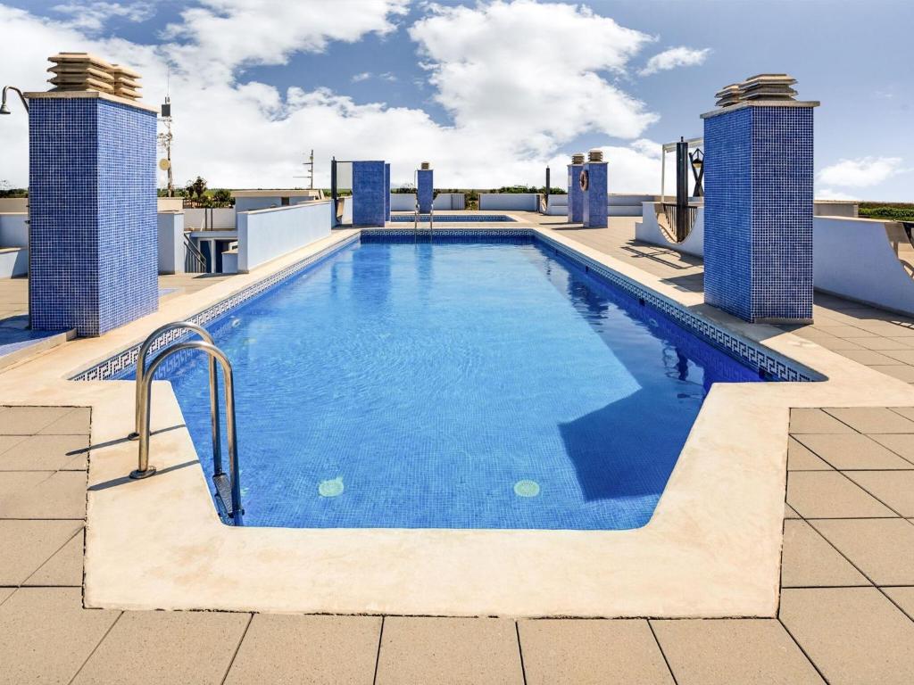 a swimming pool on the roof of a building at Comfortable Apartment in L Eucaliptus with Swimming Pool in Deltebre