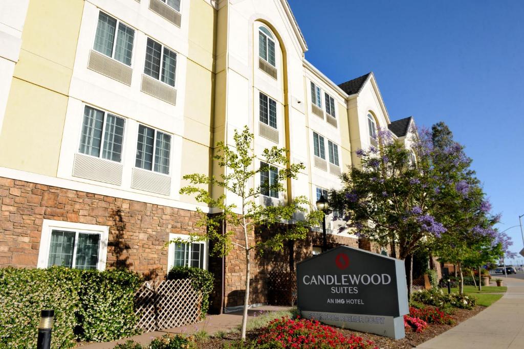 a building with a sign in front of a building at Candlewood Suites Santa Maria, an IHG Hotel in Santa Maria