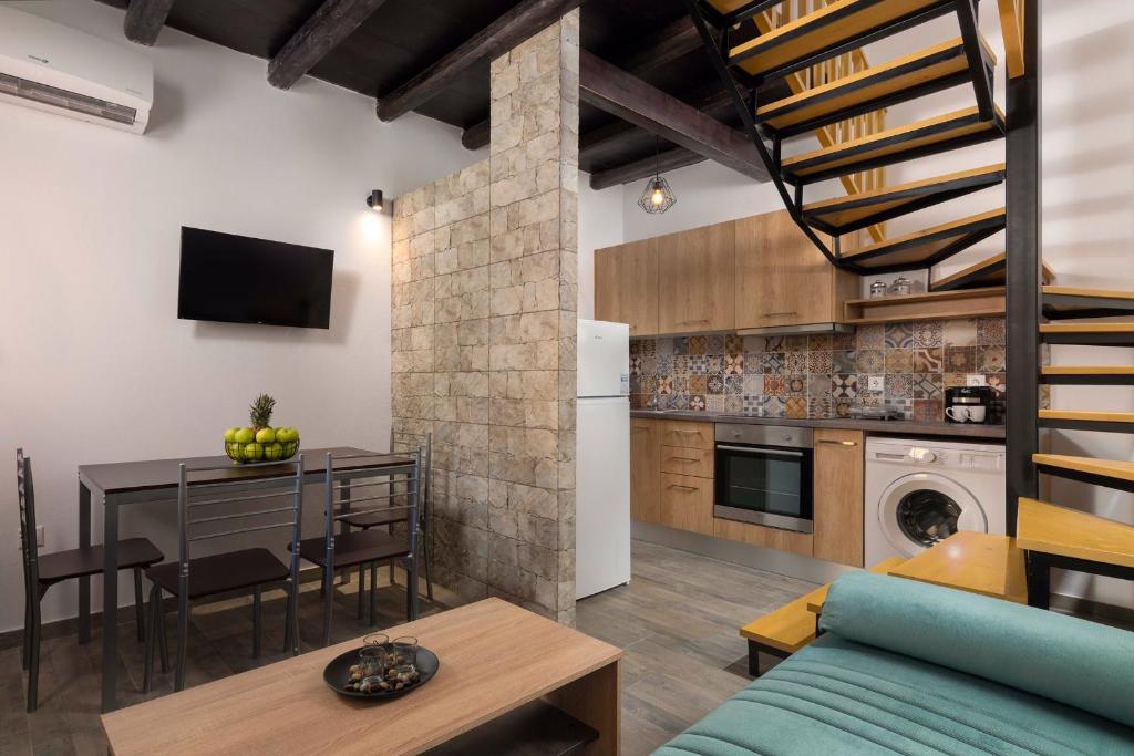 a kitchen and living room with a couch and a table at Apartments in the center marasia in Rhodes Town