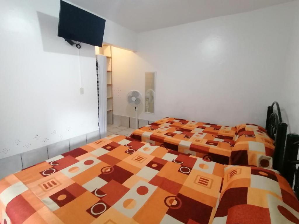 Postel nebo postele na pokoji v ubytování Hostal Maple