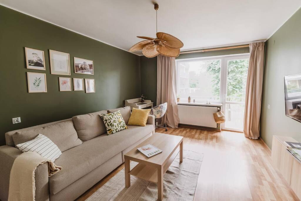 a living room with a couch and a ceiling fan at Piastowska sleeping - mieszkanie w centrum miasta in Krosno