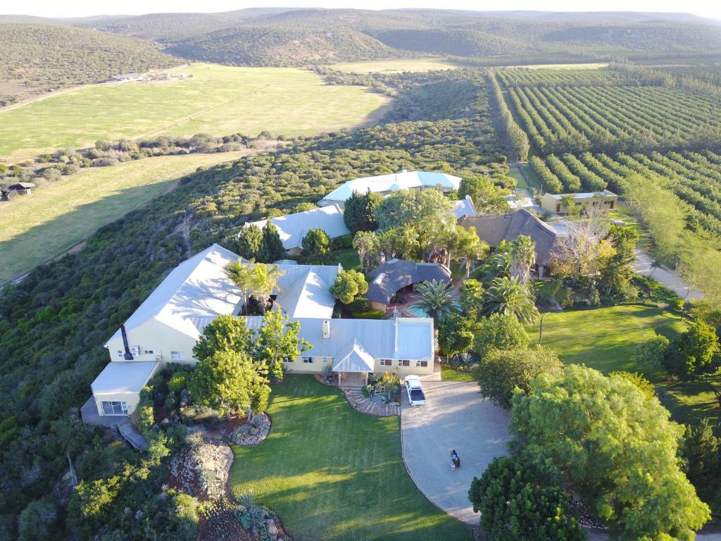 an aerial view of a large white house in a field at Kududu Guest House in Addo