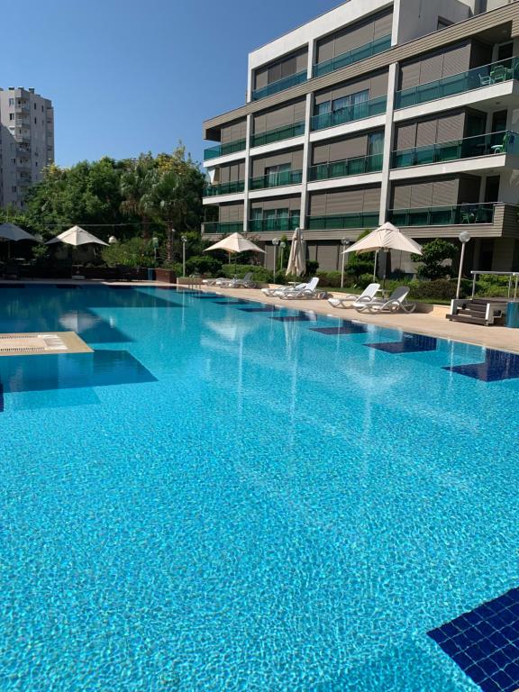 a large swimming pool in front of a building at Antalya Residence by Lara in Antalya