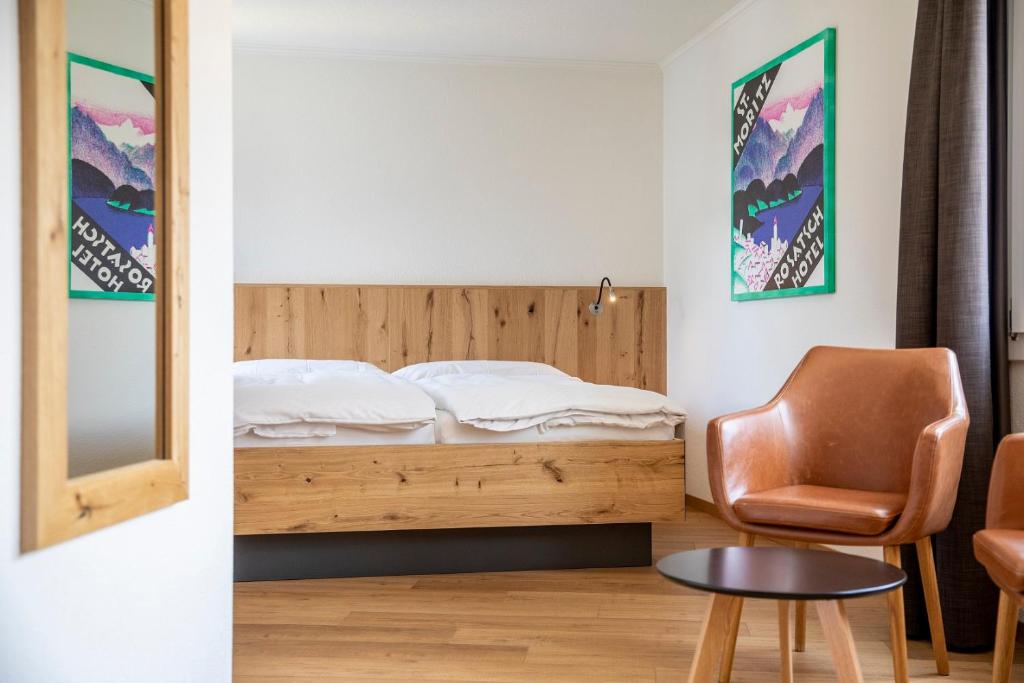 Postel nebo postele na pokoji v ubytování Hotel Meiringen