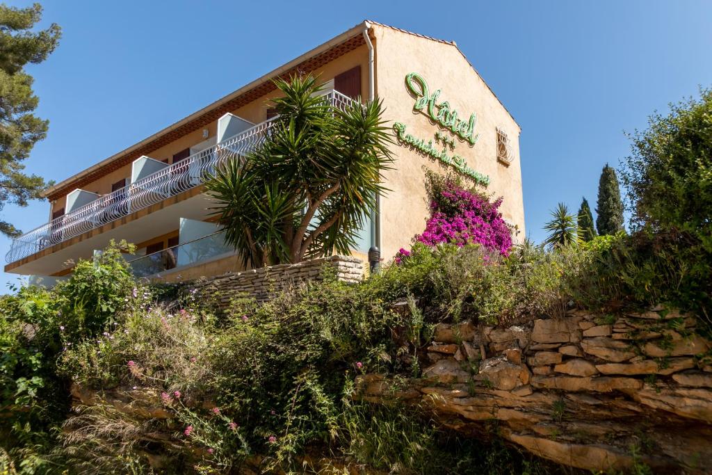 a building with a sign on the side of it at Hôtel Corniche du Liouquet in La Ciotat