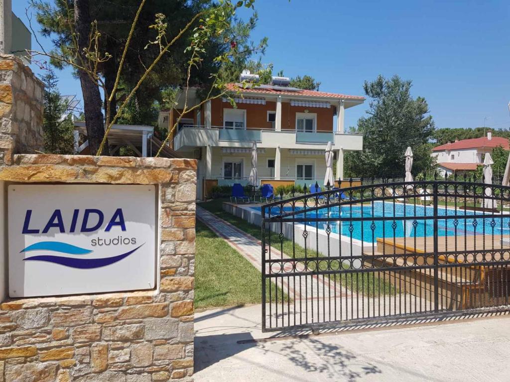 a sign for a villa with a swimming pool at Laida studios in Prinos