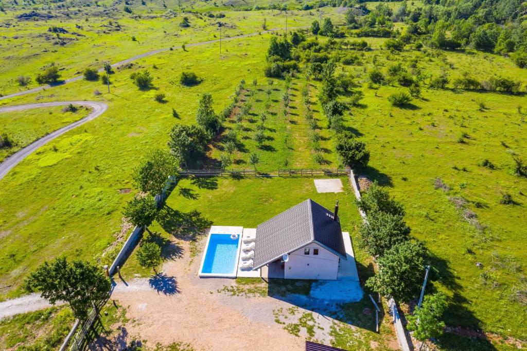 an overhead view of a small house in a field at MONA in Gračac