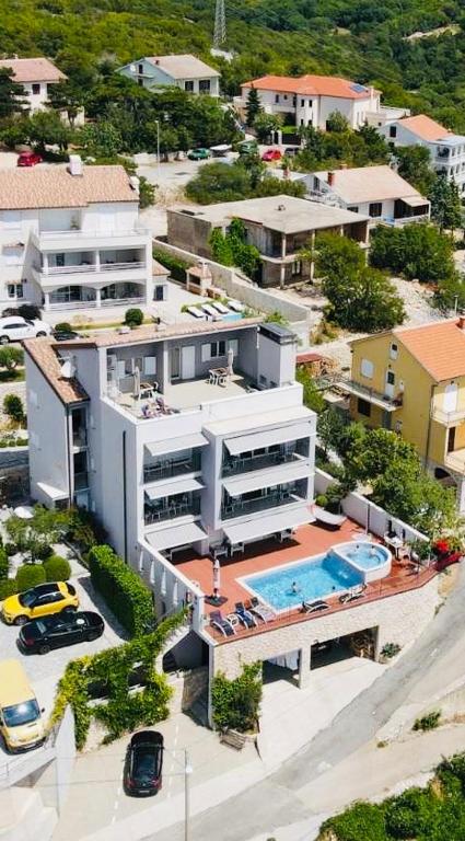 an aerial view of a building with a swimming pool at Apartments Villa Manda in Novi Vinodolski