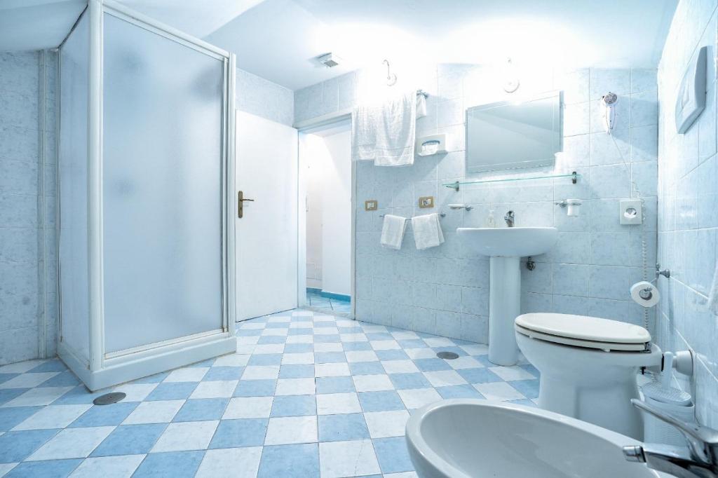 a bathroom with a toilet and a sink and a shower at Hotel Fontana in Amalfi
