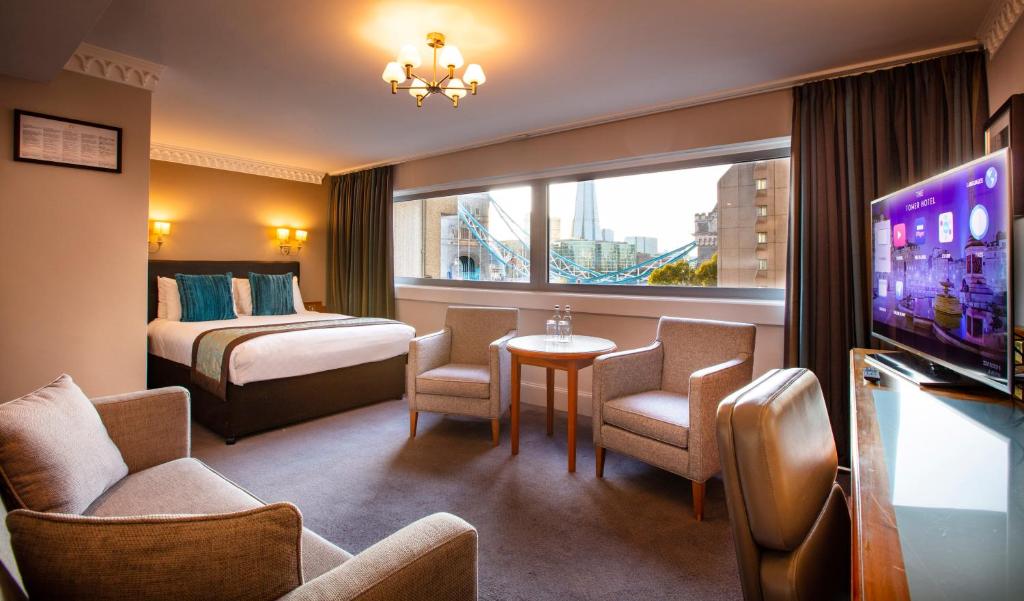 a hotel room with a bed and a tv at The Tower Hotel, by Thistle in London