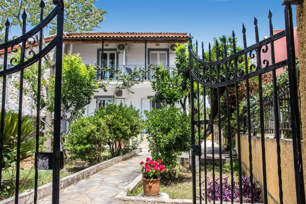 a gate to a house with flowers in front of it at Irini Apartments and Studios in Agios Gordios