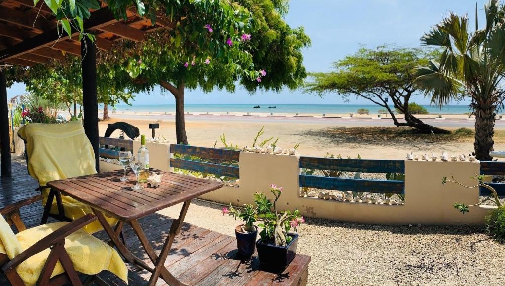 a table and chairs next to a beach at Aruba Sunset Beach Studios in Palm-Eagle Beach
